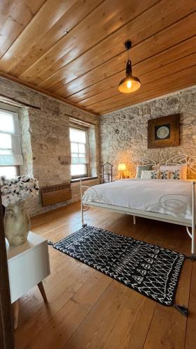 a bedroom with a bed and a wooden ceiling at SİSU ALAÇATI OTEL in Çeşme
