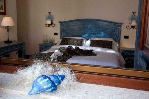 a bedroom with a bed with a large mirror at Mira Spiaggia in San Vito lo Capo
