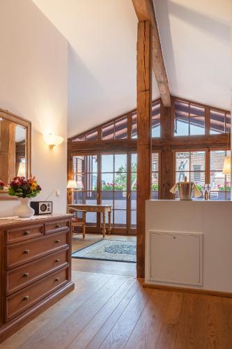a kitchen with wooden floors and a large room with windows at Landgasthof Karner in Frasdorf
