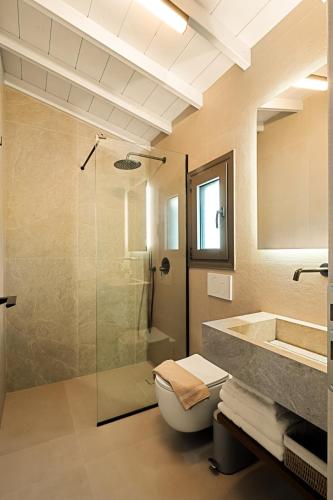 a bathroom with a shower and a toilet and a sink at Aether-Castle vista in Monemvasia