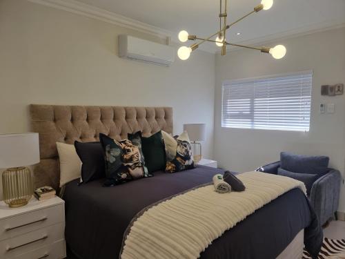 a bedroom with a large bed with a large headboard at Alice in Wonderland in Kimberley
