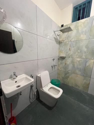 a bathroom with a toilet and a sink at Kabani By Kallar in Trivandrum