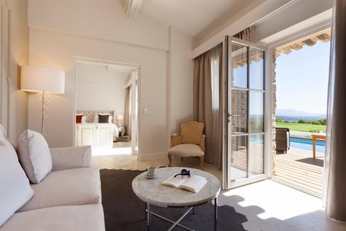 a living room with a couch and a table at Mas des Herbes Blanches Hôtel & Spa – Relais & Châteaux in Joucas