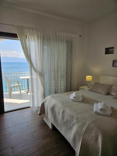 a bedroom with a bed and a view of the ocean at Villa Falcon in Podaca