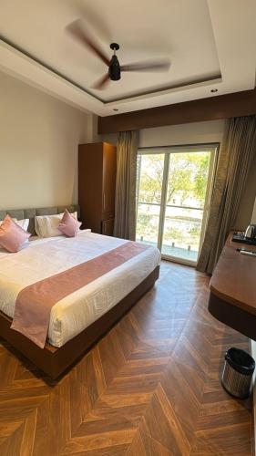 a bedroom with a large bed with a ceiling fan at Hotel Golden Bird in Dabok