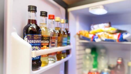 a refrigerator filled with lots of bottles of beer at Dream Hotel in Velika Gorica