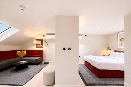 a hotel room with a bed and a couch at VCity Suites at The Teacher in Glasgow