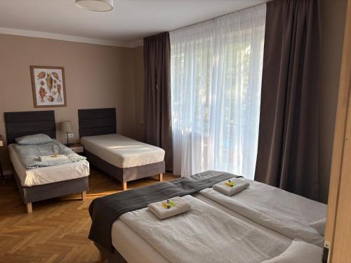 a hotel room with two beds and a window at APARTEL Piaseczno in Piaseczno