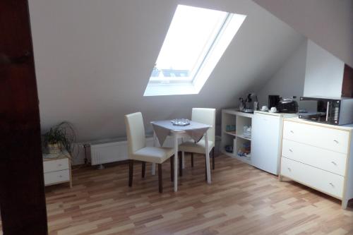 a kitchen with a table and chairs and a window at Flughafenapartement Sky View in Düsseldorf