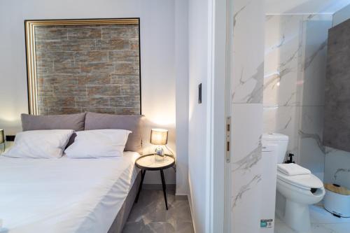 a small bedroom with a bed and a side table at Linea Nest Studio Near the Beach in Pissidhón