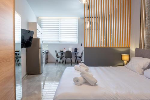 a bedroom with a bed with towels on it at Linea Nest Studio Near the Beach in Pissidhón