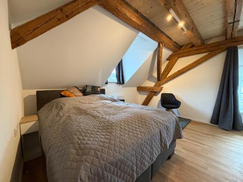 a bedroom with a large bed in a attic at Schloss Espasingen Apartment 4 in Stockach