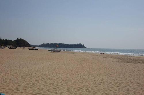 a beach with boats on the sand and the ocean at Eve Resort in Patnem