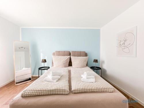 a bedroom with a large bed with two pillows at Marina Liebe in Cuxhaven