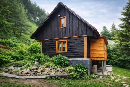 a small house with a black roof at Chata Turík in Turík