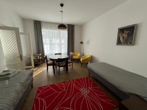 a bedroom with a bed and a table and chairs at Apartmán Na Valešince in Příbram