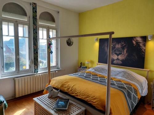 a bedroom with a bed with a poster of a lion at Cocorico in Boué