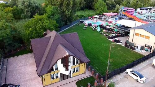 an aerial view of a house with a yard with a playground at Pensiunea Dezire in Baile Unu Mai
