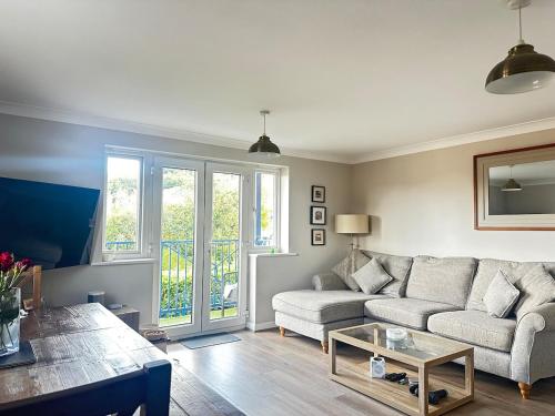a living room with a couch and a table at Castle View, Cosy Stay in Strood