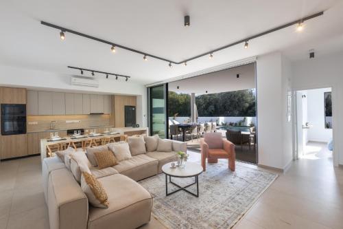 a living room with a couch and a table at Orea Luxury Villas in Ayia Napa