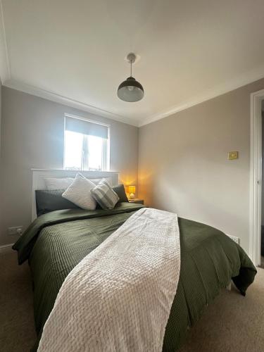 a bedroom with a large bed with a window at Castle View, Cosy Stay in Strood
