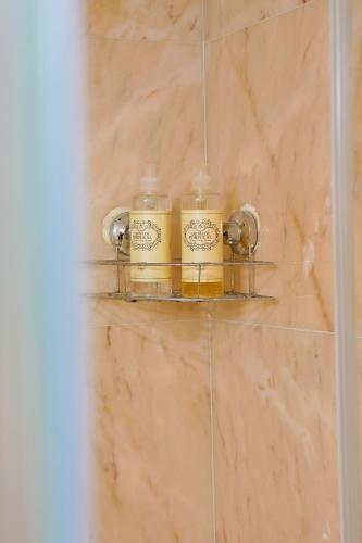 a couple of jars on a shelf in a bathroom at TM Luxury Apartments Lisbon in Lisbon