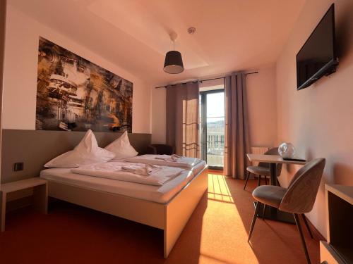 a hotel room with a bed and a desk at Pension Berlin in Cheb