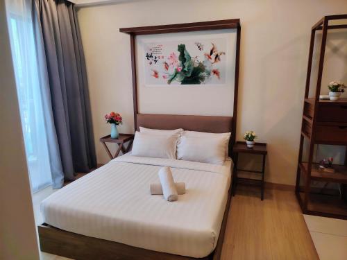 a hotel room with a bed with a white blanket at Timurbay Seafront By Ocean waves in Kuantan