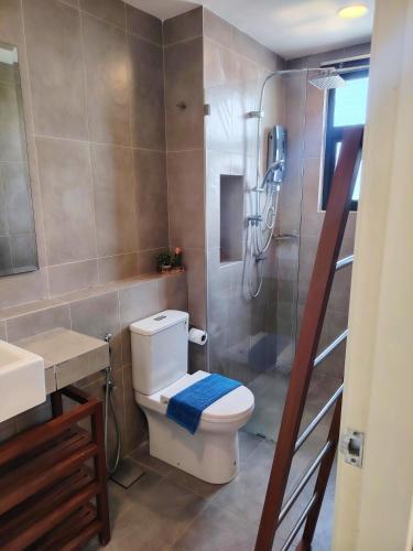 a bathroom with a shower and a toilet and a sink at Timurbay Seafront By Ocean waves in Kuantan