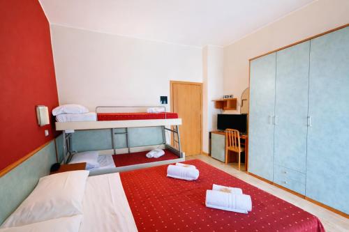a small room with two bunk beds and a kitchen at Hotel Villa Tina Easy Stay B&B in Cesenatico