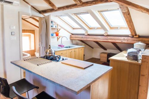 a kitchen with a counter top with skylights at Tolmin center apartments Townhouse & Loft in Tolmin