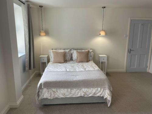 a bedroom with a bed with two tables and two lamps at Stillington Retreat in Stillington