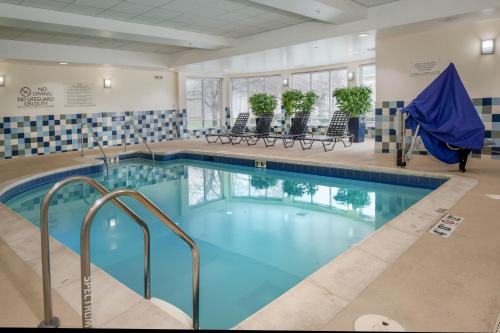 a large pool with blue water in a hotel room at Hilton Garden Inn St. Louis Airport in Berkeley