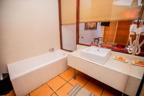 a bathroom with a sink and a bath tub at The Beach Cabanas Retreat & Spa in Koggala