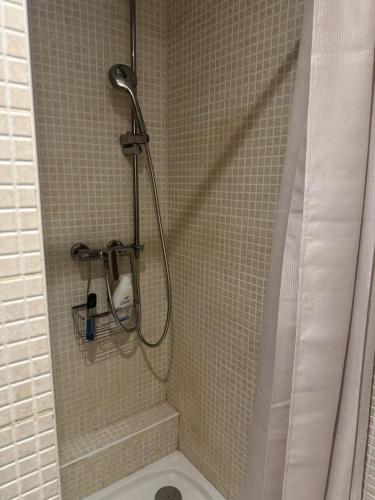 a shower with a shower head in a bathroom at Le 8 Chaussée Honfleur in Honfleur
