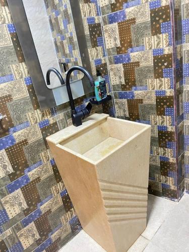a sink in a bathroom with a mosaic wall at Nefertiti guest house view pyramids in Cairo