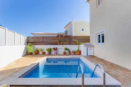 a swimming pool in the backyard of a house at Villa Arpeggio - Cozy 3-Bedroom Villa with Private Pool in Montinhos da Luz, Lagos in Mato Porcas