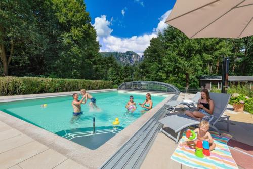a group of children playing in a swimming pool at Laasenhof in Struppen