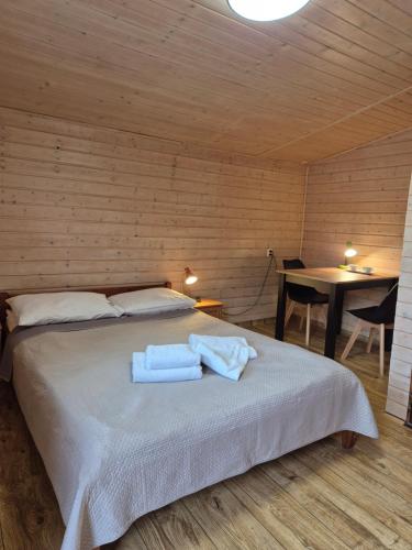 a bedroom with a bed with two towels on it at Agroturystyka U BOŻENY in Przysłup
