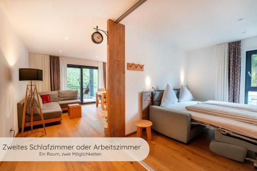 a bedroom with a bed and a living room at INVITA Natur-Chalets - Familienurlaub im Schwarzwald in Bad Dürrheim