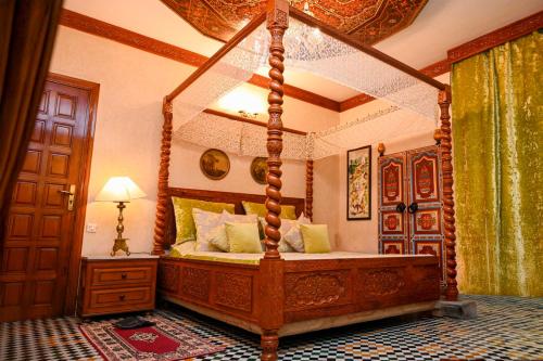 a bedroom with a canopy bed in a room at Dar Maya Original Suite & Spa in Fez