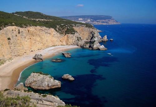 an aerial view of a beach with rocks in the water at Sesimbra Horizon in Sesimbra