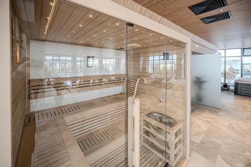a barber shop with a glass wall at Eleven Odyssey Apartment in Năvodari