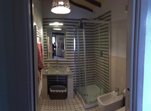 a bathroom with a shower and a sink and a tub at Casa la Quiete in Torgiano