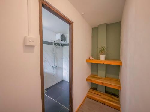 a walk in shower in a room with a glass door at The Mount View Single Tree Hotel in Nuwara Eliya