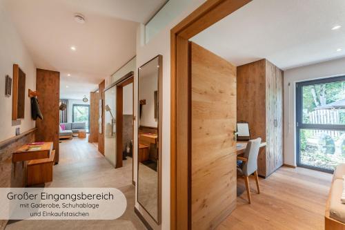 a pivot door in a home office with a desk at INVITA Natur-Chalets - Familienurlaub im Schwarzwald in Bad Dürrheim