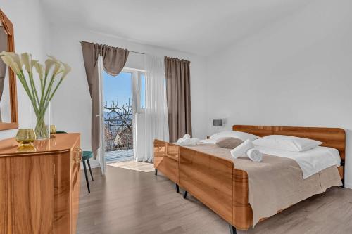 a bedroom with a bed and a large window at Apartment Green Valley in Imotski