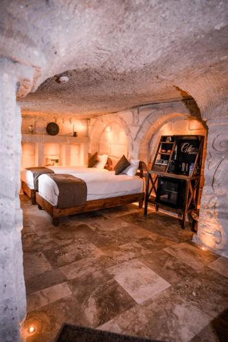 a bedroom with a bed in a stone room at Lost City Cappadocia in Nar