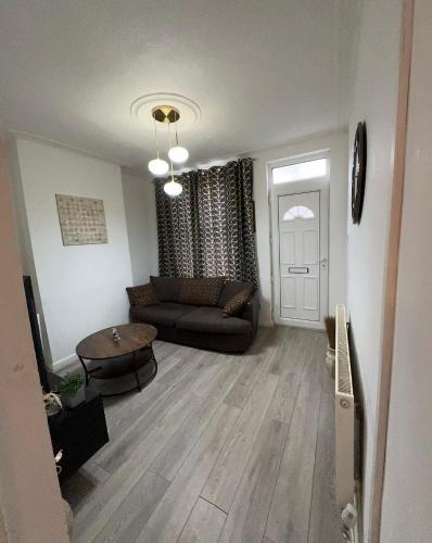 a living room with a couch and a table at F2S SERVICED APARTMENTS 2Bedroom Terrace house with Free Wifi Netflix Suitable for Contractors walking distance to Train station in Derby
