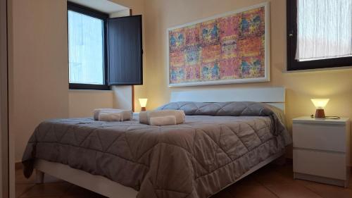 a bedroom with a bed with two pillows on it at Gaia Holidays Apartments in Cefalù